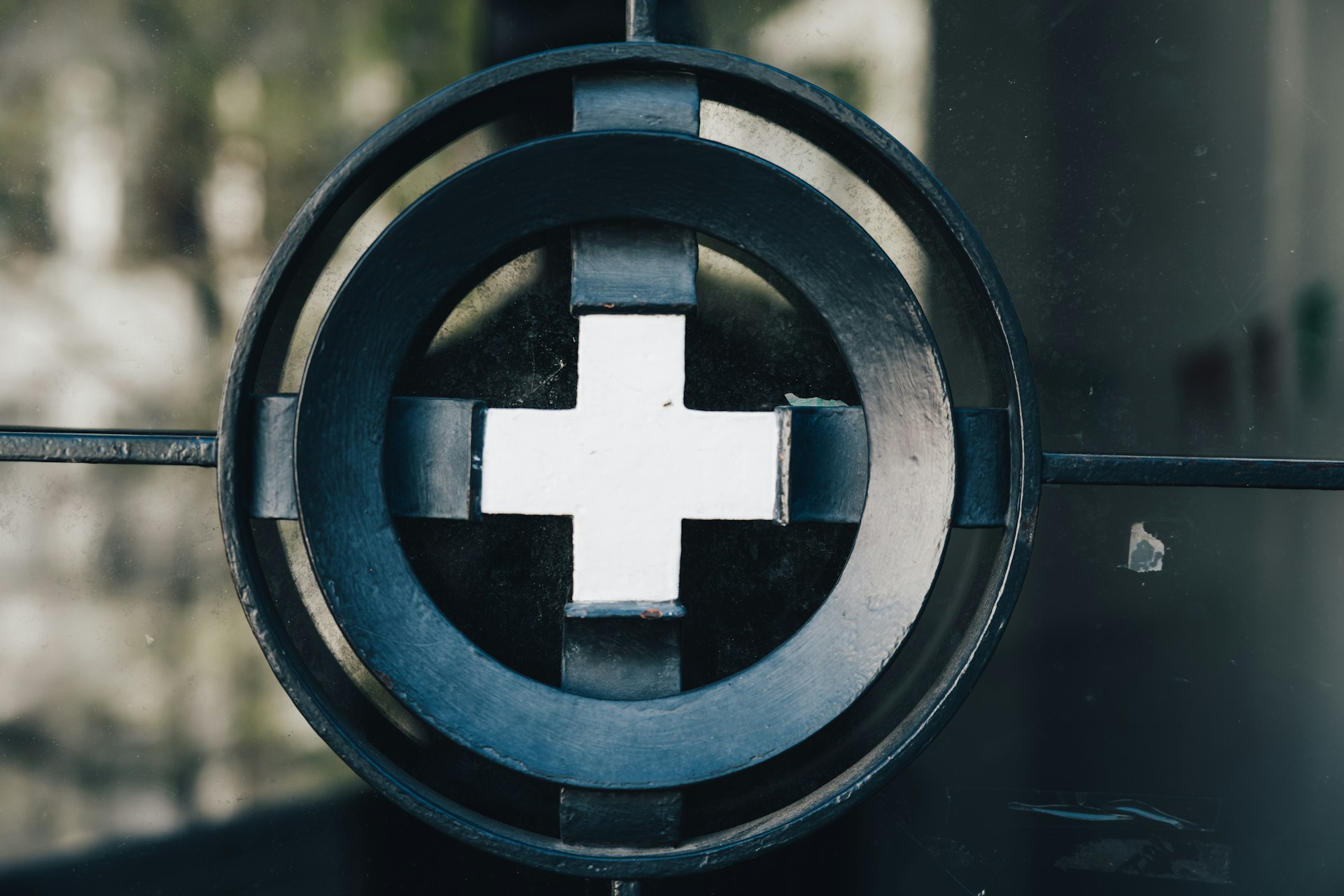 a close up of a metal object with a cross on it